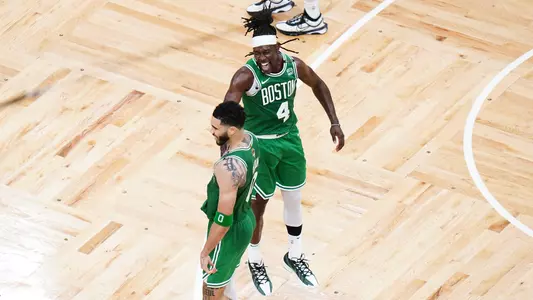 Jun 17, 2024; Boston, Massachusetts, USA; Boston Celtics forward Jayson Tatum (0) reacts with guard Jrue Holiday (4) in the fourth quarter against the Dallas Mavericks during game five of the 2024 NBA Finals at TD Garden. Mandatory Credit: David Butler II-USA TODAY Sports