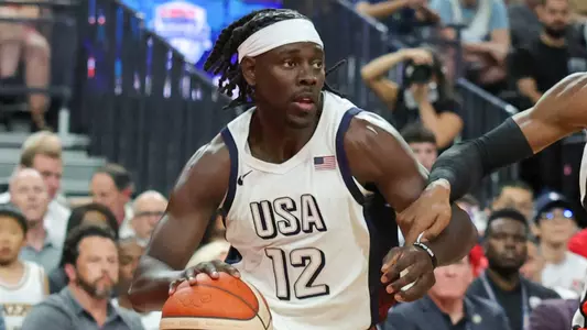 LAS VEGAS, NEVADA - JULY 10: Jrue Holiday #12 of the United States drives against RJ Barrett #9 of Canada in the second half of their exhibition game ahead of the Paris Olympic Games at T-Mobile Arena on July 10, 2024 in Las Vegas, Nevada. The United States defeated Canada 86-72. (Photo by Ethan Miller/Getty Images)