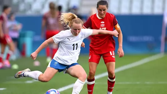 SAINT-ETIENNE, FRANCE - JULY 25: Katie Kitching #11 of Team New Zealand passes the ball under pressure Jessie Fleming #17 of Team Canada during the Women's group A match between Canada and New Zealand during the Olympic Games Paris 2024 at Stade Geoffroy-Guichard on July 25, 2024 in Saint-Etienne, France. (Photo by Tullio M. Puglia/Getty Images)