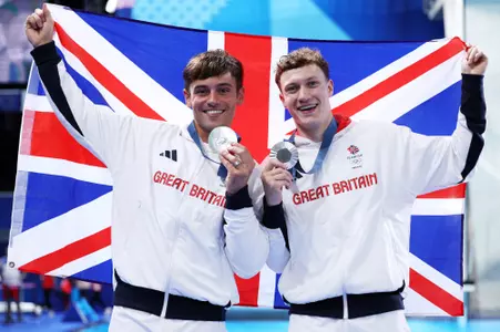 PARIS, FRANCE - JULY 29: Silver Medalists Thomas Daley and Noah Williams of Team Great Britain pose with the national flag of Team Great Britain following the Diving medal ceremony after the Menโs Synchronised 10m Platform Final on day three of the Olympic Games Paris 2024 at Aquatics Centre on July 29, 2024 in Paris, France. (Photo by Clive Rose/Getty Images)