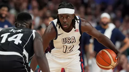 Jul 31, 2024; Villeneuve-d'Ascq, France; United States guard Jrue Holiday (12) dribbles against South Sudan shooting guard Peter Jok (14) in the fourth quarter during the Paris 2024 Olympic Summer Games at Stade Pierre-Mauroy. Mandatory Credit: John David Mercer-USA TODAY Sports