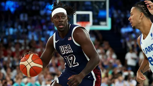 PARIS, FRANCE - AUGUST 10: Jrue Holiday #12 of Team United States drives past Matthew Strazel #85 of Team France during the Men's Gold Medal game between Team France and Team United States on day fifteen of the Olympic Games Paris 2024 at Bercy Arena on August 10, 2024 in Paris, France. (Photo by Gregory Shamus/Getty Images)