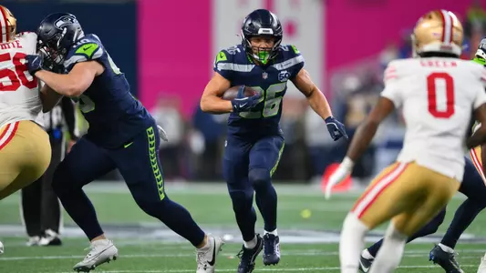Jan 17, 2026; Seattle, WA, USA; Seattle Seahawks running back Zach Charbonnet (26) carries the ball against the San Francisco 49ers during the first half in an NFC Divisional Round game at Lumen Field. Mandatory Credit: Steven Bisig-Imagn Images