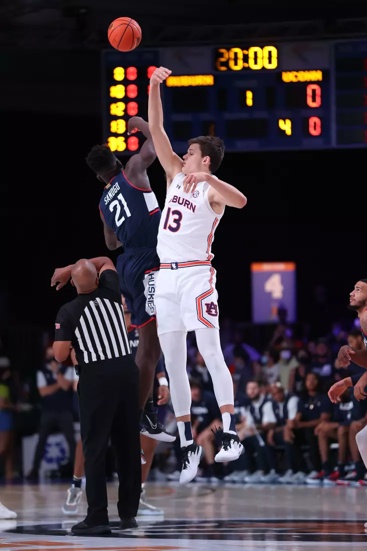 Connecticut Huskies forward Adama Sanogo (21) gets the tip off over Auburn Tigers forward Walker Kessler (13) at the Battle 4 Atlantis Wednesday, November 24, 2021 at Atlantis, Paradise Island in the Bahamas. (Photo by Tim Aylen)