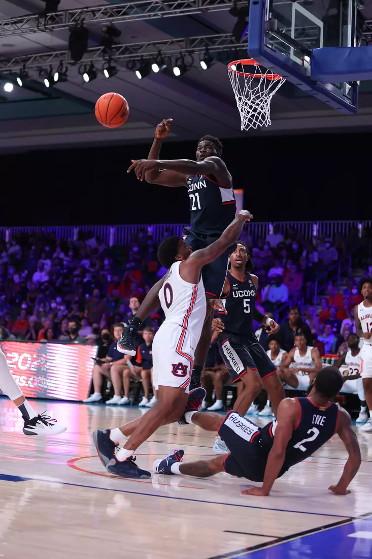 Auburn Tigers guard K.D. Johnson (0) blocked by Connecticut Huskies forward Adama Sanogo (21) at the Battle 4 Atlantis Wednesday, November 24, 2021 at Atlantis, Paradise Island in the Bahamas. (Photo by Tim Aylen)