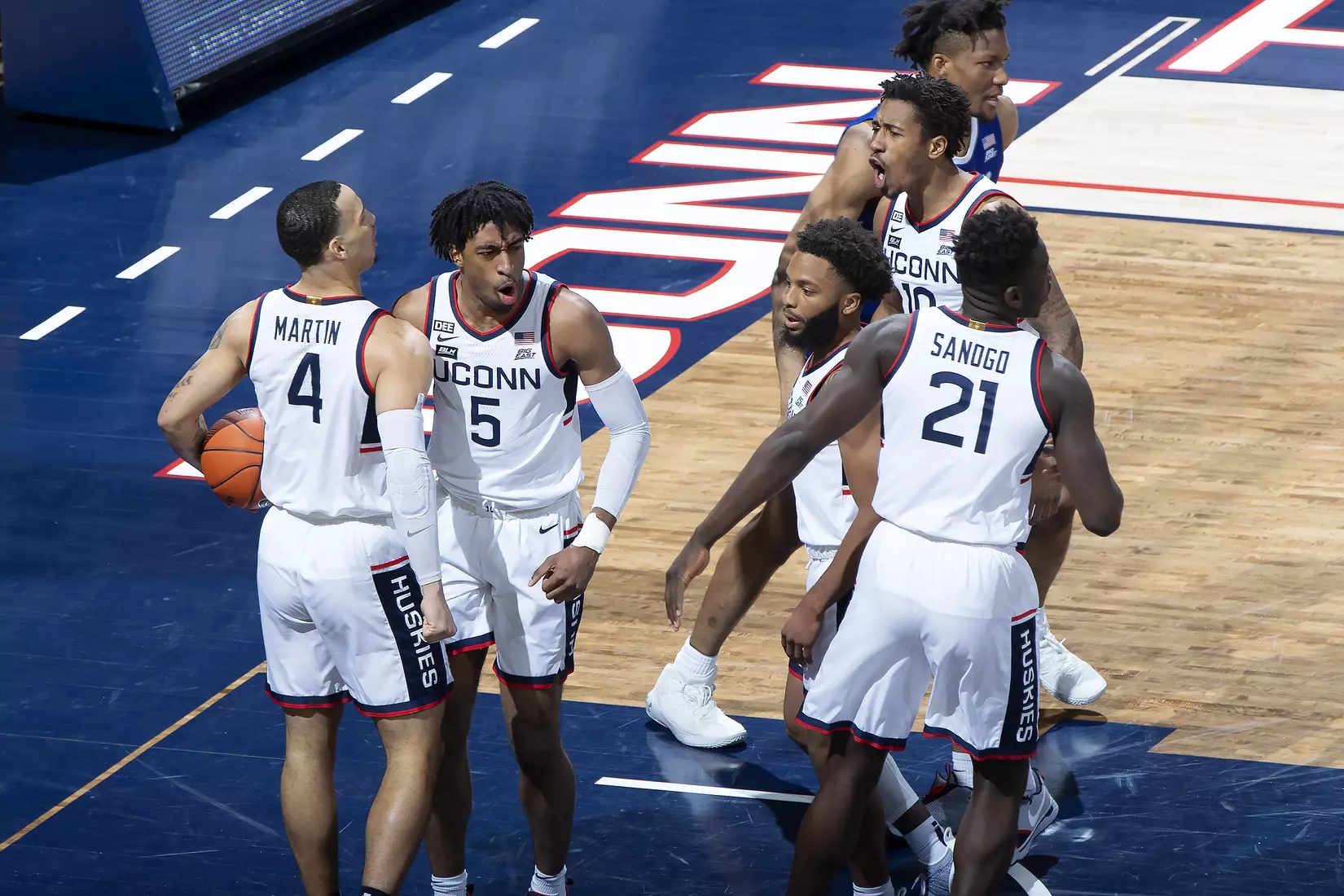 The Huskies celebrate after a bucket against Seton Hall on February 6, 2021.
