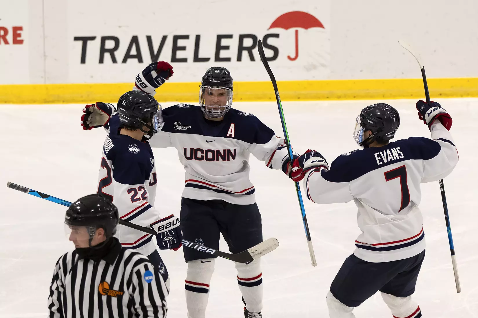 Carter Turnbull celebrates with Jonny Evans and Hudson Schandor after Turnbull's second goal of the season against UMass Lowell on December 21, 2020.