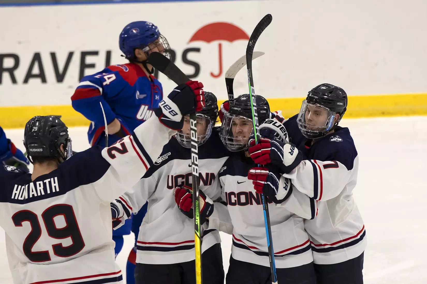 The Huskies celebrate following a goal against UMass Lowell on December 21, 2020.