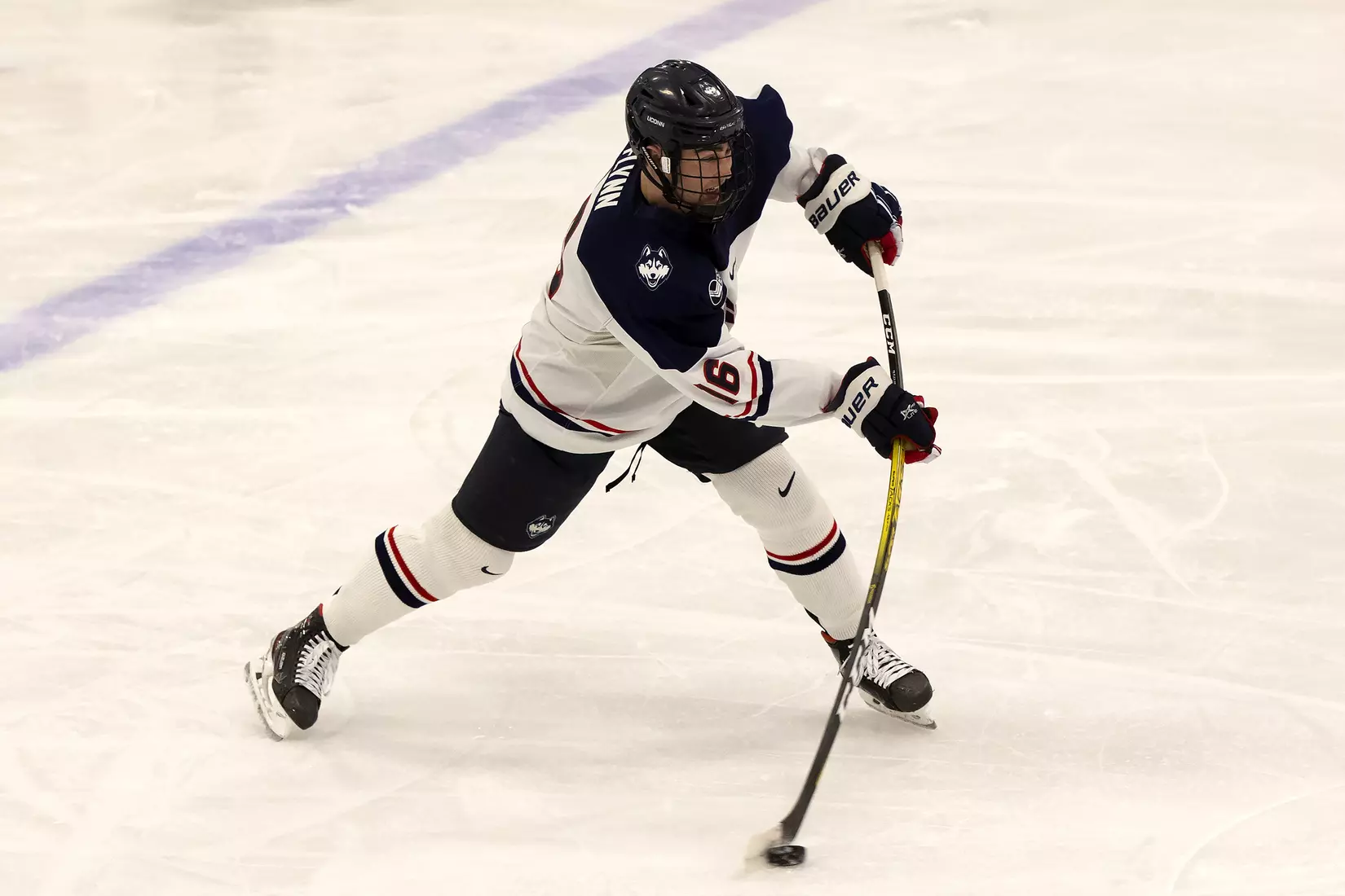 Jake Flynn takes a slap shot against UMass Lowell on December 21, 2020.