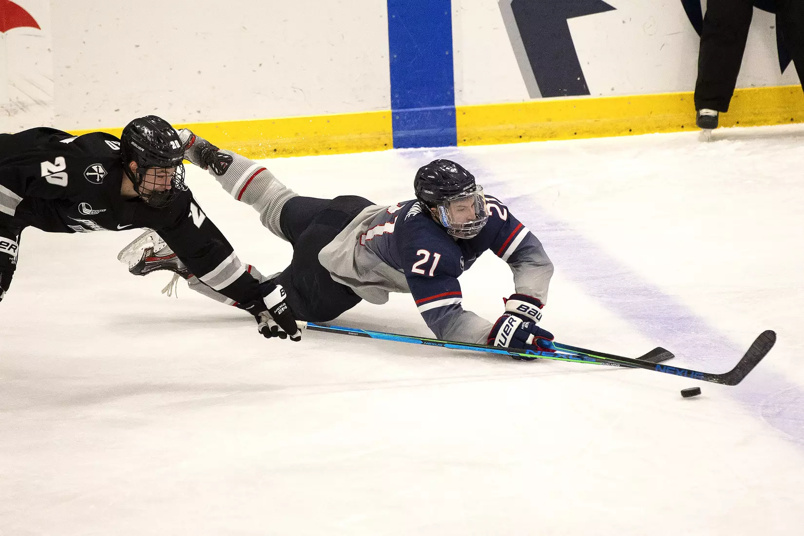 Nick Capone fights for the puck against Providence on December 28, 2020.