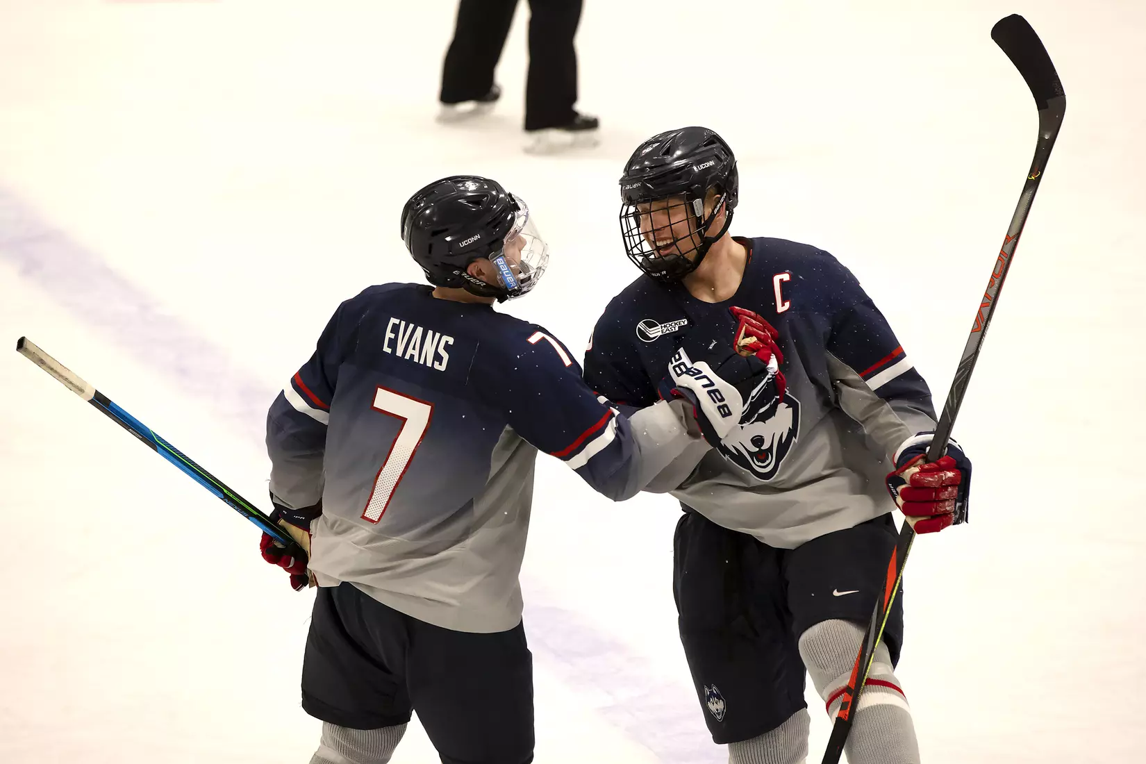 Jonny Evans and Adam Karashik celebrate Huskies win over Providence on December 28, 2020.