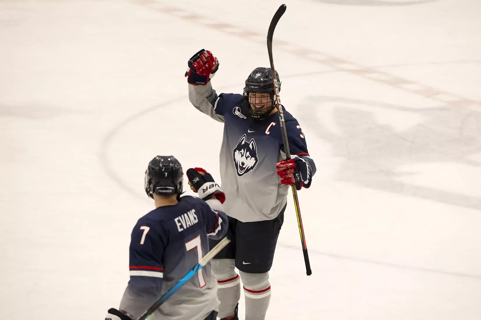 Jonny Evans and Adam Karashik celebrate Huskies win over Providence on December 28, 2020.
