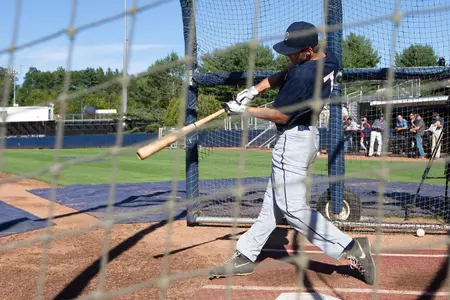 Griffin Garabedian takes a cut as scouts look on at UConn Scout Day