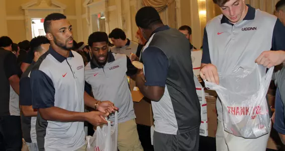 Noel Thomas and Arkeel Newsome bag groceries at Fill The Bowl.