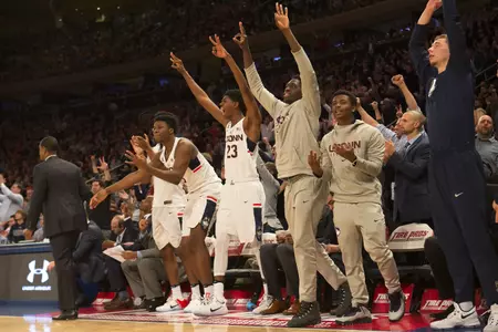 UConn bench celebrating during Monday night's game at MSG.