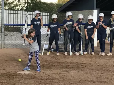 Abbie taking batting practice with UConn softball on Tuesday.