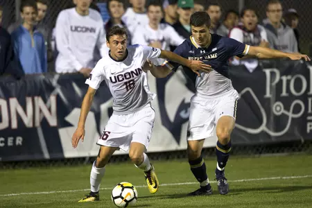 Freshman Austin DaSilva fends-off a Notre Dame defender (Steve Slade).