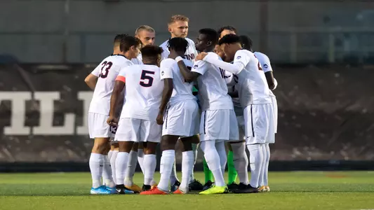 The Men's Soccer team huddles up