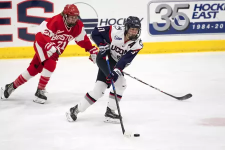 Briana Colangelo controls the puck in a game against BU