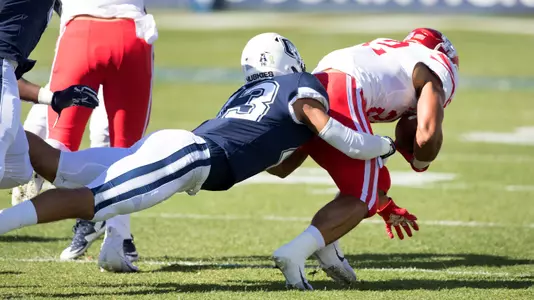 Jackson Mitchell tackles a Houston ball carrier