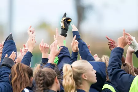 The women's soccer team huddles before game vs UCF