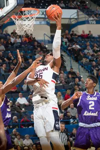 Josh Carlton lays the ball up against St. Michael's
