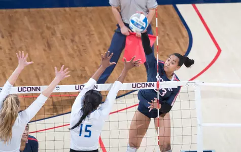 Jasmine Davis spikes the ball against Tulsa