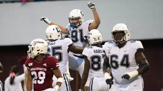 Jay Rose celebrates with his teammates after catching a TD pass against UMass on October 26.