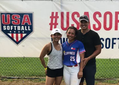Reese with her parents softball