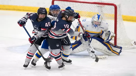 Leona Sim and Daniella Fox fight for a puck versus Ryerson