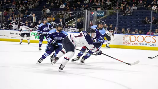 Jonny Evans shoots in a game against Maine
