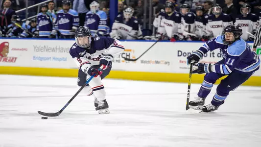 Carter Turnbull controls the puck in a game against Maine