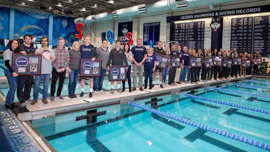 Seniors on the Swim team with their families on Senior day