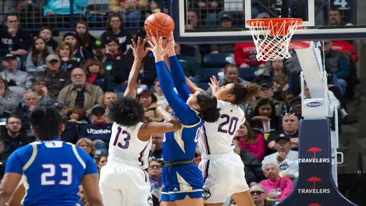Christyn Williams and Olivia Nelson-Ododa fight for a rebound against Tulsa