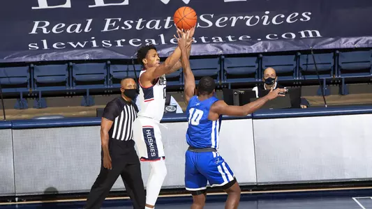 Brendan Adams takes a three-pointer in the Huskies' win over CCSU on November 25.