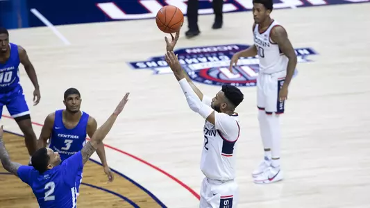 Tyler Polley takes a three-pointer in the Huskies' win over CCSU on November 25.