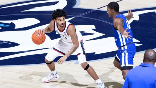 Jalen Gaffney dribbles over midcourt in the Huskies' win over CCSU on November 25.