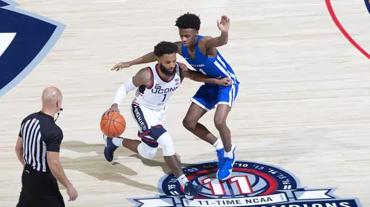 RJ Cole dribbles past midcourt in the Huskies' win over CCSU on November 25.
