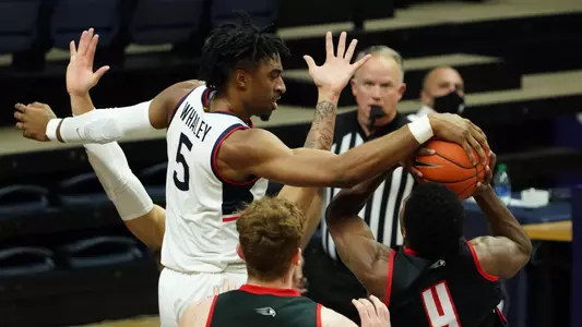 Isaiah Whaley blocks a shot against Hartford on November 27.