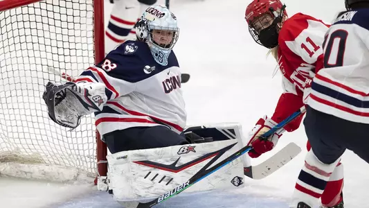 Tia Chan makes a save against BU on December 11, 2020.