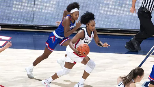 Christyn Williams dribbles up the floor against UMass-Lowell on December 12, 2020.