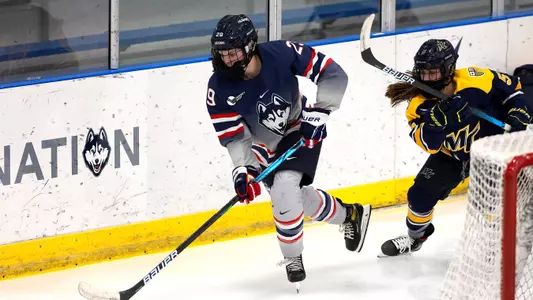Kate Klassen controls the puck behind the Merrimack net on December 18, 2020.