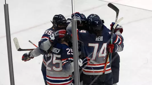 The team celebrates after a goal against Merrimack on December 18, 2020.