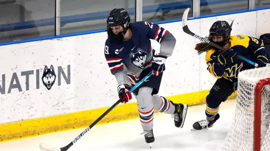Kate Klassen controls the puck behind the Merrimack net on December 18, 2020.