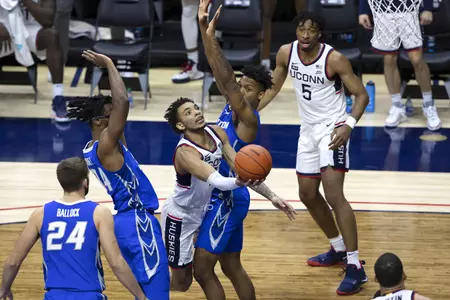 James Bouknight drives through two defenders for the basket in the game against Creighton on December 20th 2020