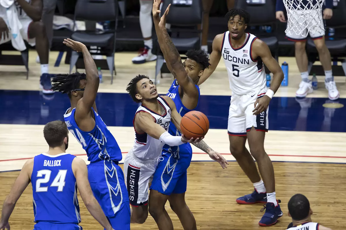 James Bouknight drives through two defenders for the basket in the game against Creighton on December 20th 2020