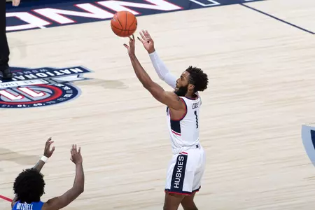 Rj Cole takes 3 point shot over the defender in the game against Creighton on December 20th 2020