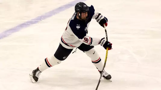 Jake Flynn takes a slap shot against UMass Lowell on December 21, 2020.
