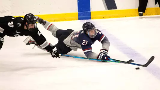 Nick Capone fights for the puck against Providence on December 28, 2020.