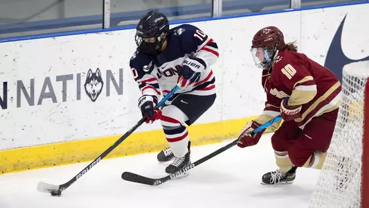 ALEXANDRA-ANNE BOYER skates around the net and evades a BC defender